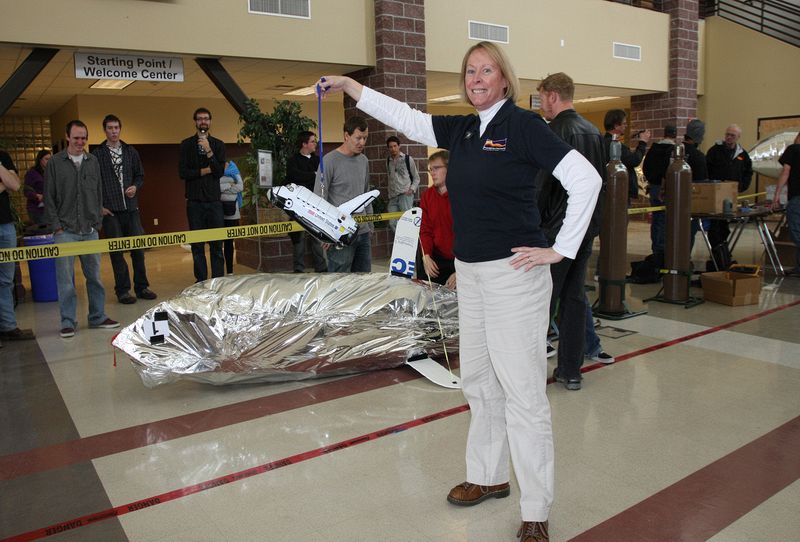 Sue Fitzgerald, Nevada NASA Space Grant Consortium staff member compares the Space Shuttle to one of the team LTA designs.